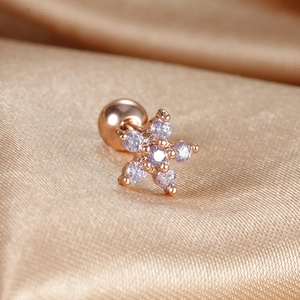Macro detail of rose gold flower stud earrings with lavender gemstones and screw backs