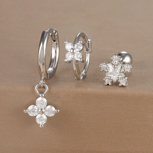 Macro detail of silver geometric flower earrings set with micro-inlaid cubic zirconia
