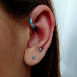 Conjunto de tres pendientes turquesa y plata en modelo para un estilo moderno