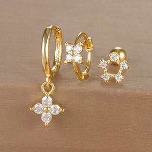 Macro detail of gold floral earrings set with S925 hallmark and sparkling zircon stones