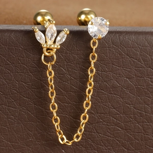 Detail van gouden dubbele oorbellen met marquise-zirkonia en fijne schakelketting