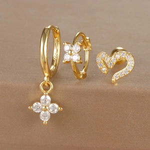 Macro shot of 18K gold plated S925 silver earrings set with zircon clover and heart studs