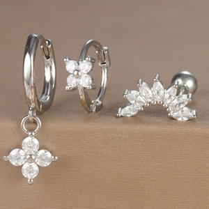 Macro shot of silver earring set with floral zircon pendants and marquise-cut accents