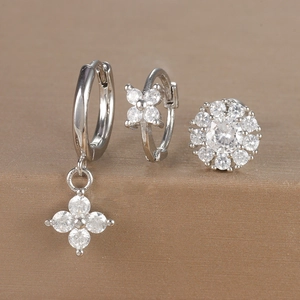 Detailed view of silver floral earrings set with micro-set zircons and polished finish
