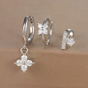 Detail of silver earring set with floral and star cubic zirconia in macro view