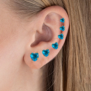 Detailed view of heart-shaped blue zircon studs with gold-plated screw ball backings