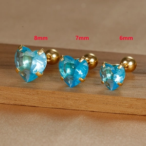 Detailed macro view of heart-shaped blue crystal studs in 8mm, 7mm, and 6mm sizes