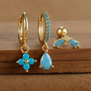 Detail view of gold-plated S925 silver earrings set with blue turquoise stones and engraving