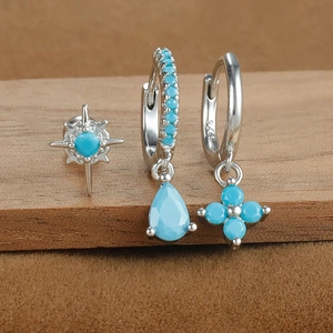 Macro shot of S925 sterling silver turquoise earring set with star and teardrop charms