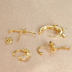 Macro detail of 18k gold plated flower tassel earrings with emerald cut zircon stones