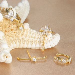 Golden flower and butterfly zircon earring set on silk fabric for elegant beach look
