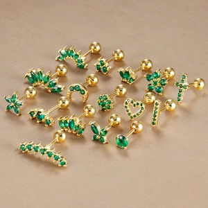 Detail of green zircon crown cartilage earrings with gold-plated screw ball backs