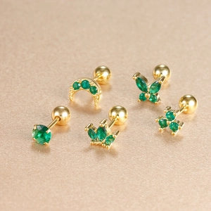 Detail view of five-piece gold stud set with green zircon crown and moon motifs