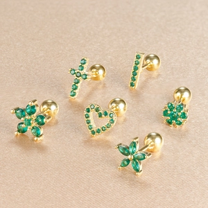 Detailed macro view of gold screw-back earrings with green zircon in six floral designs