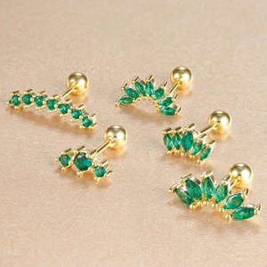 Close-up of five green zircon crown stud earrings with gold plating and screw-back