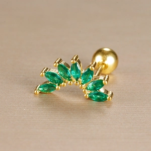 Macro shot of gold stainless steel tragus stud with green marquise stones and screw ball back