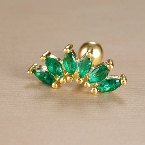 Macro view of golden piercing stud with five marquise green stones and ball back