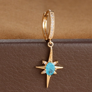 Vintage gold starburst drop earrings with blue stone and sparkling diamond accents