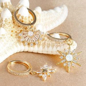 Pendientes dorados elegantes con colgantes de estrella y piedras de circón
