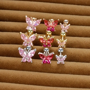Macro detail of butterfly stud earrings with colorful zircon and screw ball backing