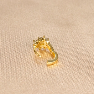 Close-up of golden floral ear cuff featuring micro-set zircon and hinge detail