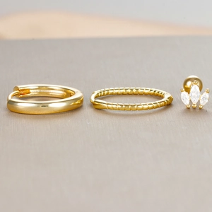 Three-piece set of gold twist hoop earrings and marquise-cut zircon stud earrings