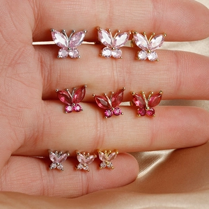 Macro view of butterfly zircon earrings in various sizes and metallic finishes