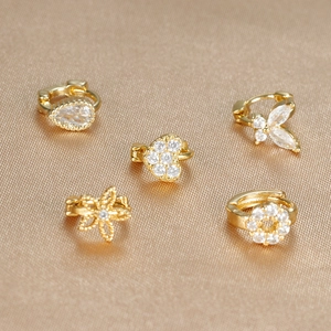 Set of five gold ear cuffs with zircon heart, star, butterfly, and teardrop shapes