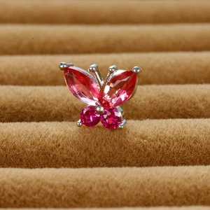 Macro shot of silver butterfly stud earring featuring vibrant pink marquise crystals