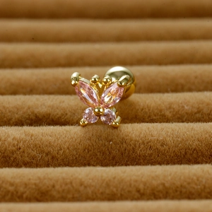 Macro detail of butterfly ear stud with pink zircon stones and gold screw ball back