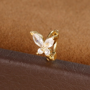 Macro shot of gold butterfly ear cuff with shimmering marquise and round cubic zirconia