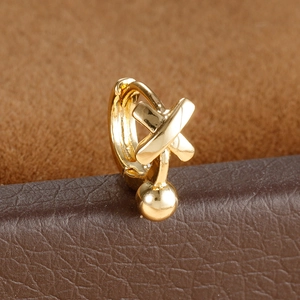 Close-up of gold hoop earrings with X-shaped design and hanging metal bead detail
