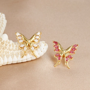 Elegant 316L gold-plated butterfly cartilage earrings with marquise-cut gems on satin