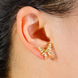 Macro detail of a 316L butterfly cartilage stud with white zircon butterfly wings