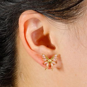 Close-up of a pink butterfly cartilage stud earring in gold-plated 316L steel