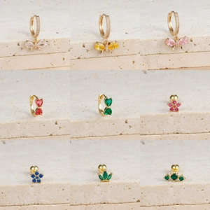 Detailed grid of gold earrings with cubic zirconia hearts, butterflies, and floral charms