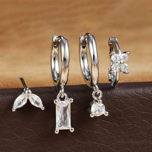 Silver earring set with marquise and rectangular zircons on dark leather texture