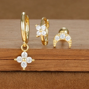 Detail of gold-plated S925 earrings set with white zircon flowers and crescent moon