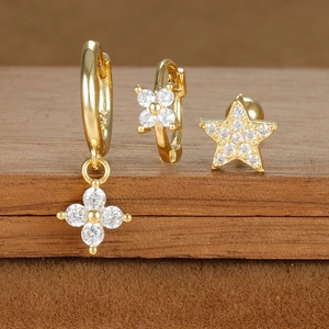 Close-up of gold star and flower earrings set with S925 hallmark and sparkling zircon