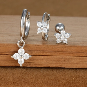 Silver star and moon earring set with cubic zirconia on geometric wooden display