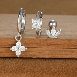 Detailed view of silver star and flower earring set with sparkling cubic zirconia crystals