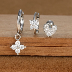 Detailed view of silver star and heart stud earrings set with sparkling zircon stones