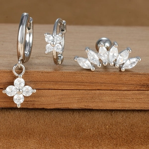 Macro detail of silver geometric earring set with star and moon zircon crystals
