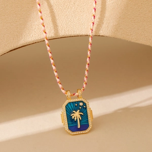 Détail du pendentif tarot palmier doré avec émail bleu et bordure de cristaux fins