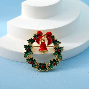 Detailed Christmas wreath brooch with green enamel leaves, red bow, and crystal accents