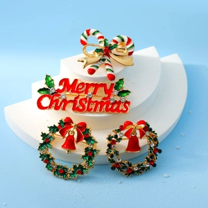 Christmas brooch set with candy cane and wreath on a snowy winter background
