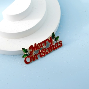 Red Merry Christmas script brooch with green holly leaves and white rhinestones