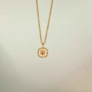 Elegant gold necklace with red resin gemstone and sparkling starburst pendant for women