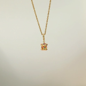Golden necklace featuring a vibrant carousel horse pendant with colorful enamel and zircons