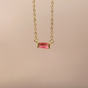 Gold stainless steel birthstone necklace featuring a rectangular pink zircon pendant